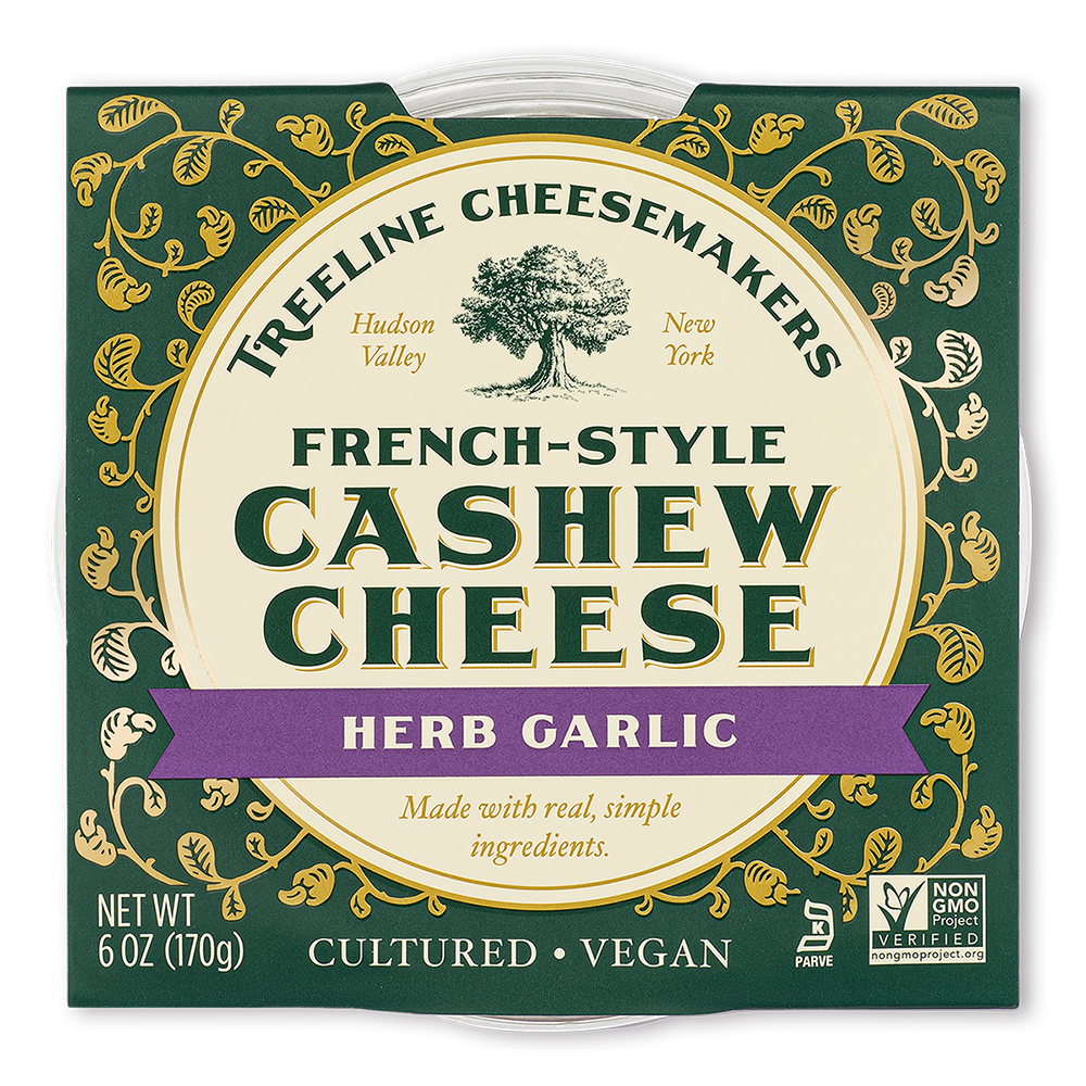 Treeline Herb Garlic French-Style Cashew Cheese in its green and gold packaging