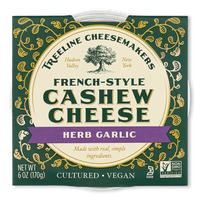 Treeline Herb Garlic French-Style Cashew Cheese in its green and gold packaging