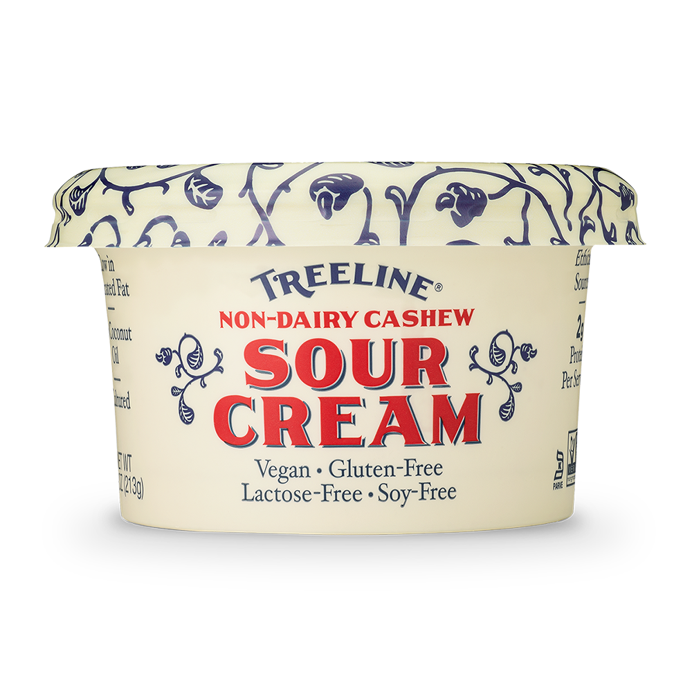 Treeline Non-Dairy Cashew Sour Cream in its cream, red, and blue packaging