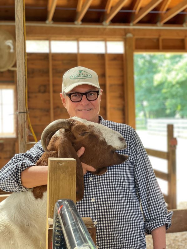 treeline cheesemakers founder holding a goat